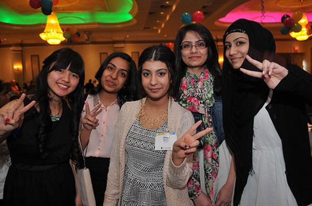 Five female volunteers stand together and smile at a PLASP volunteer appreciation event